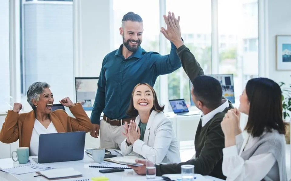 co workers high fiving